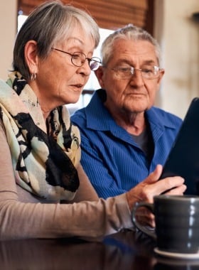senior couple using a tablet
